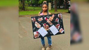 Art student Ms Aphiwe Khalishwayo with her work on Gender-Based Violence.
